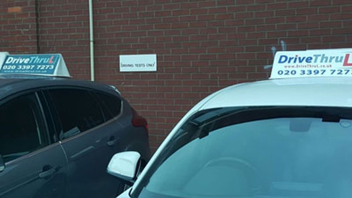 DriveThruL tuition cars parked in a bay signed driving tests only