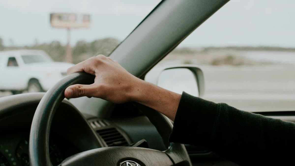 Driver's hand on the steering wheel of a right hand drive car
