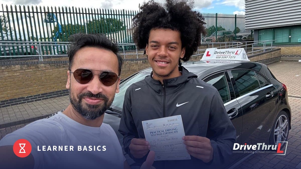 DriveThruL instructor and pupil with a pass certificate on test day