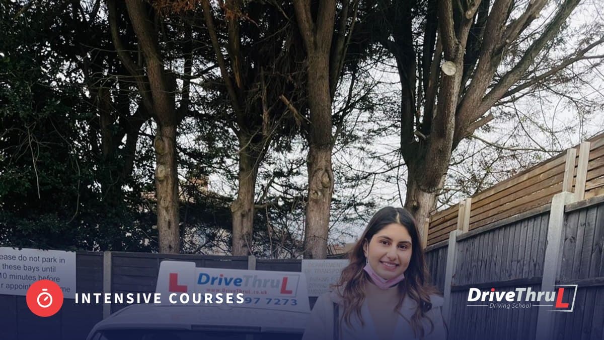 DriveThruL pupil with her pass certificate beside the car