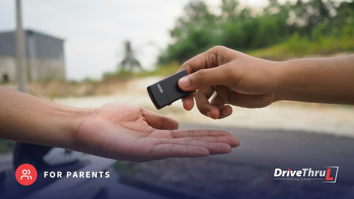 One hand passing a car key to another
