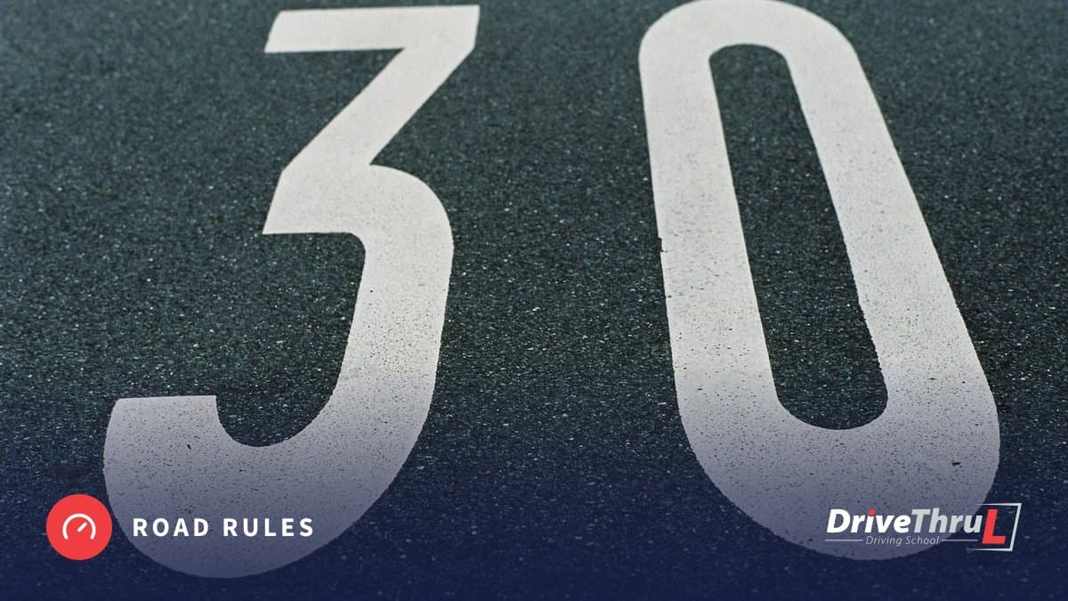 A 30 speed limit painted on the road surface