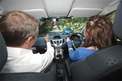 Driving lessons for nervous and anxious drivers in East London Nervous driver driving lesson East London - patient instructor guiding anxious learner in dual control car