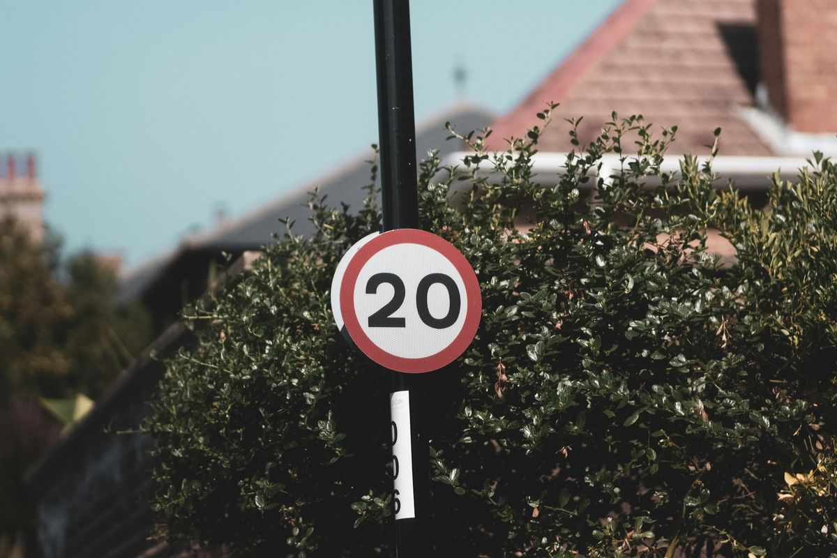 A 20 speed limit sign on a residential street