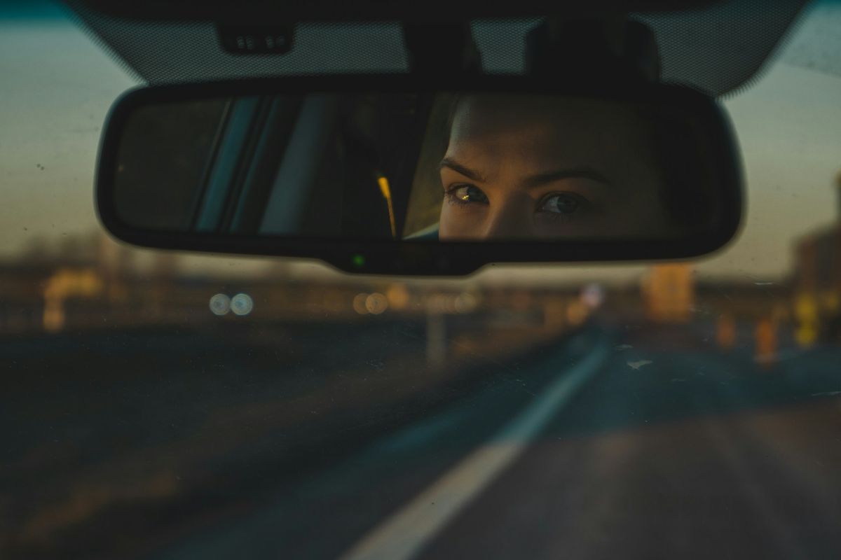 A driver’s eyes in the rear-view mirror
