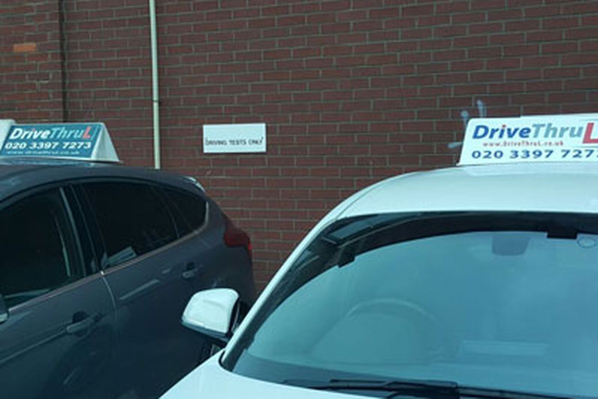 DriveThruL tuition cars parked in a bay signed Driving tests only