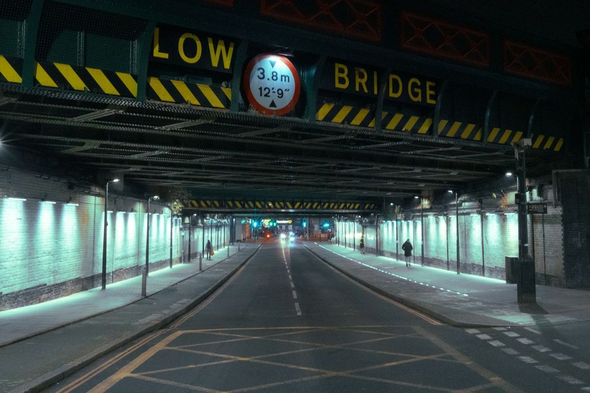 Red circle sign limiting vehicle height to 3.8 metres at a low bridge