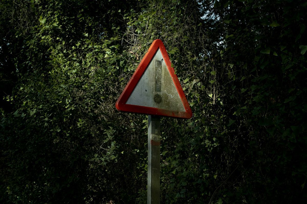 Red triangle warning sign at the roadside
