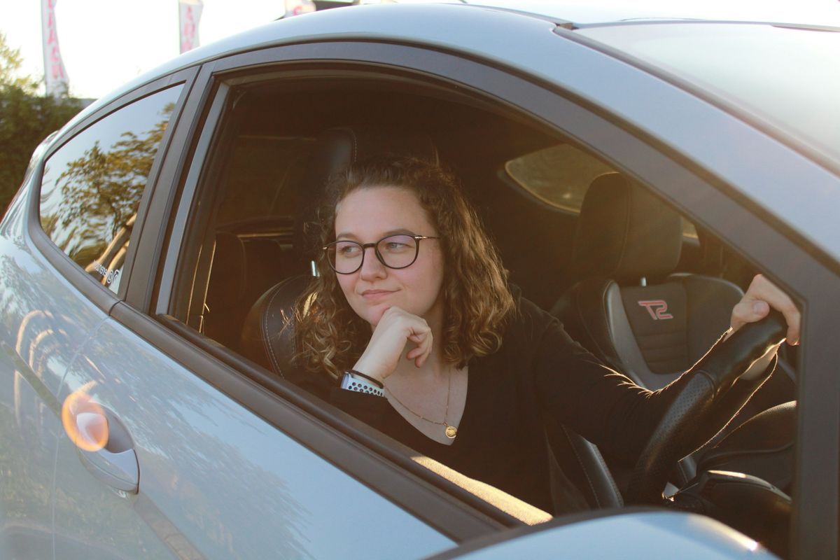Smiling driver at the wheel of a right-hand-drive car