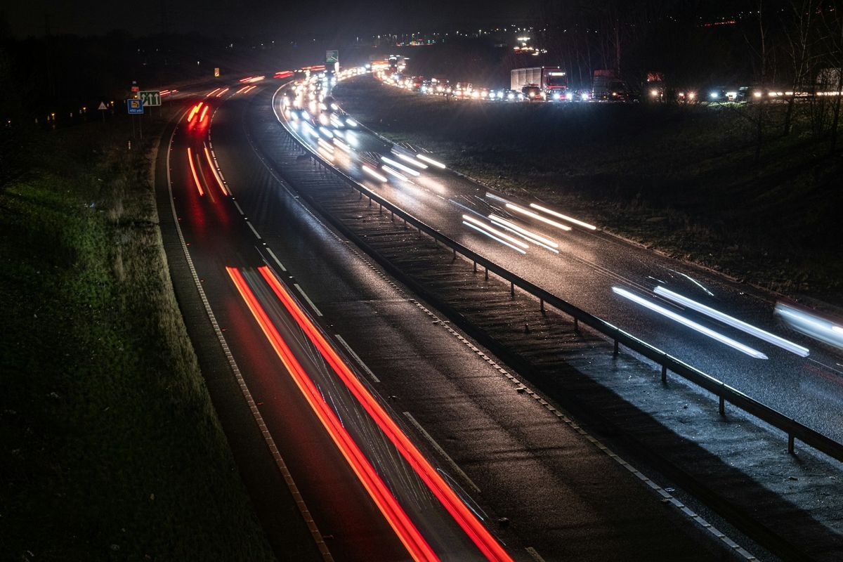Traffic on a multi-lane road at night, keeping left