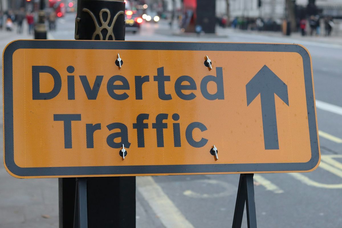 Yellow Diverted traffic sign with an arrow
